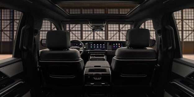 2027 GMC Sierra 1500 interior featuring premium seating, a spacious cabin, panoramic sunroof, and a large digital infotainment display.